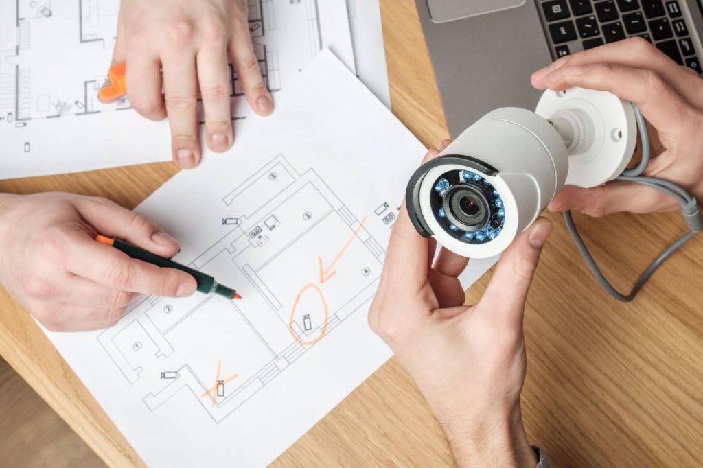 Contractors Discussing Best Position To Install CCTV